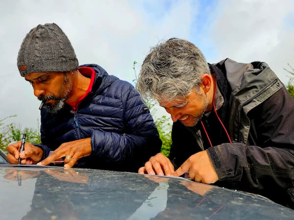 2 personen die op een kaart tekenen